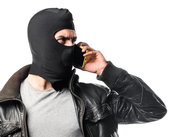 Robber talking to mobile — Stock Photo, Image