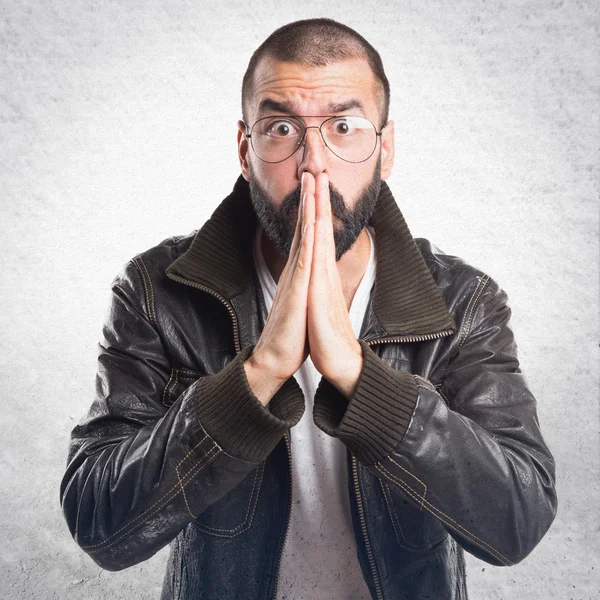 Man with leather jacket pleading — Stock Photo, Image