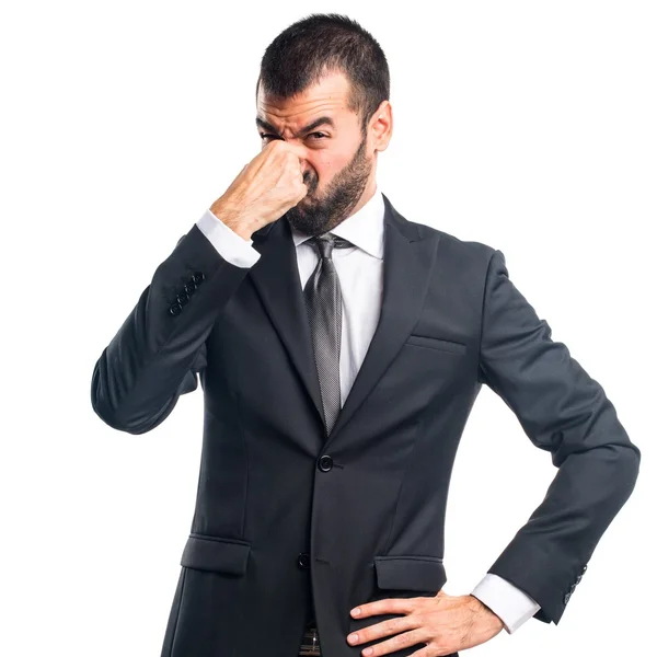 Businessman making smelling bad gesture — Stock Photo, Image