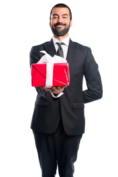 Businessman holding a gift — Stock Photo, Image