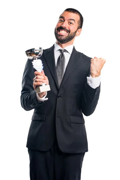 Hombre de negocios sosteniendo un trofeo —  Fotos de Stock