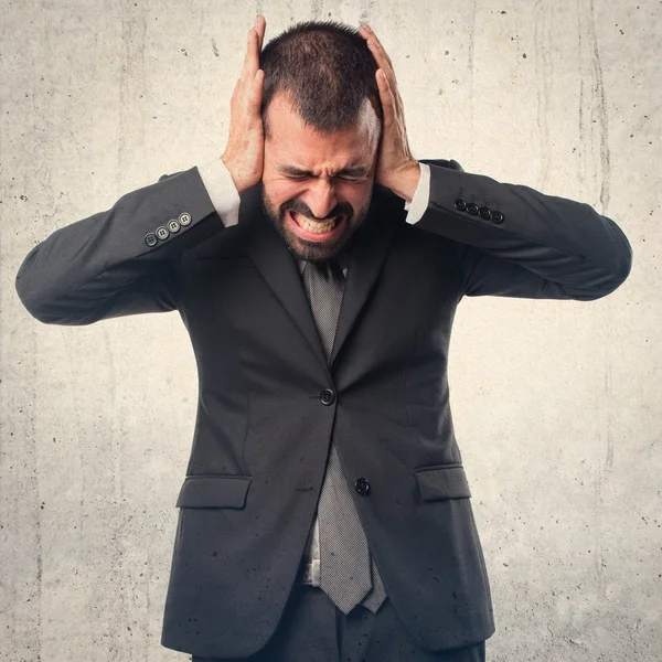 Businessman covering his ears — Stock Photo, Image