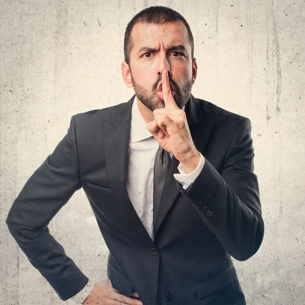 Businessman making silence gesture — Stock Photo, Image