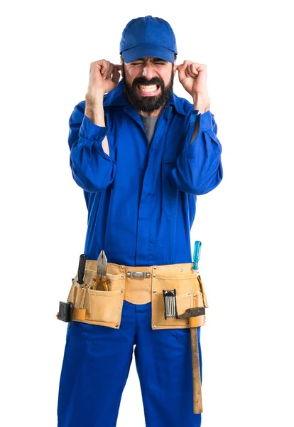 Plumber covering his ears — Stock Photo, Image