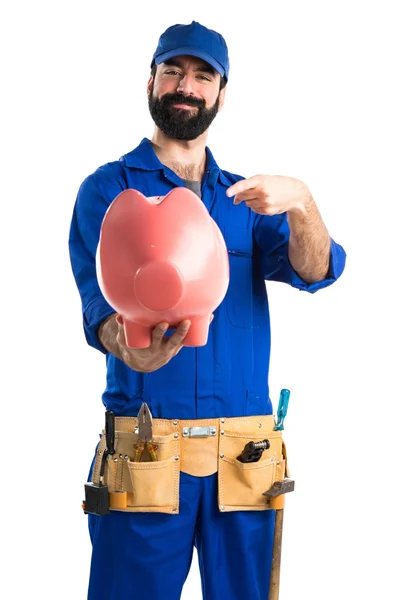 Plumber holding a piggybank — Stock Photo, Image