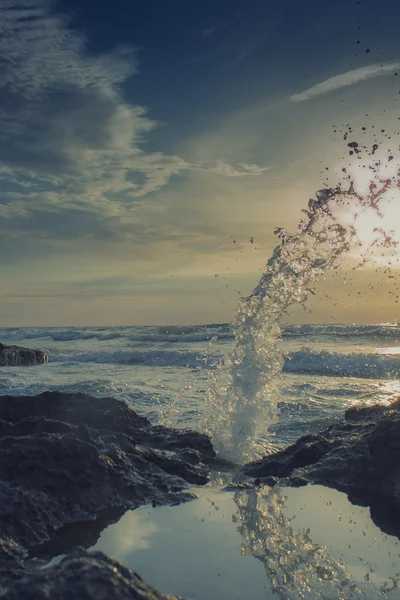 Sunrise on sea beach and splash — Stock Photo, Image