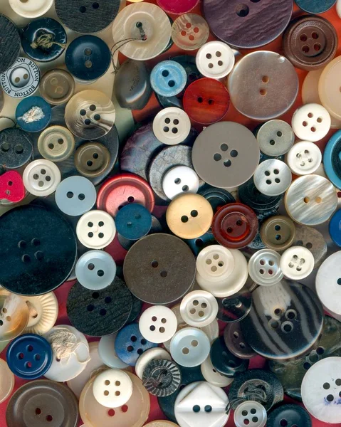Close up buttons, macro colorful image. Collection of assorted spare clothes buttons vintage. Sewing tools. Color buttons frame on fabric texture background wallpaper