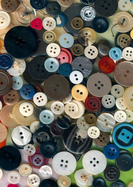 Close up buttons sewing, macro colorful image. Collection of assorted spare clothes buttons vintage. Sewing tools. Color buttons frame on fabric texture background wallpaper