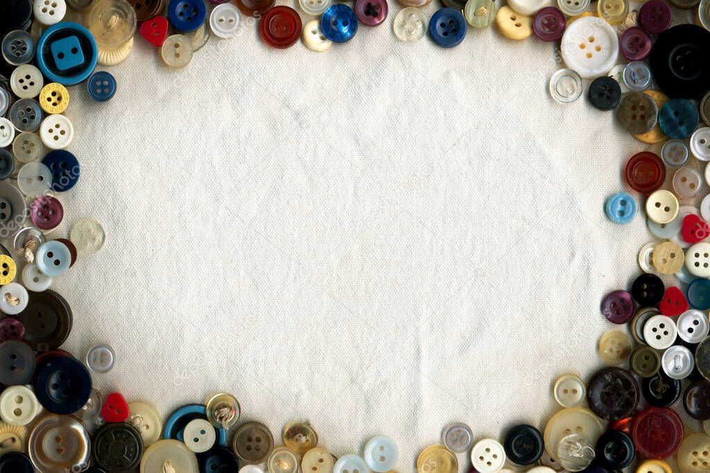 Sewing color buttons frame on fabric texture background. Collection of assorted spare clothes buttons vintage. Sewing tools close up. 
