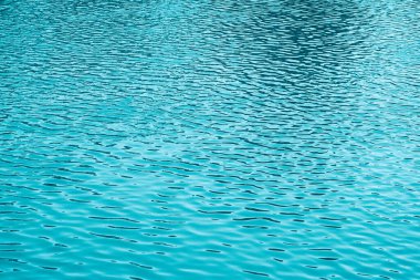 Mavi su arka planı. Denizin sakin yüzeyi. Okyanus. Doğal soyut arka plan. Film tahılları ve gürültü.