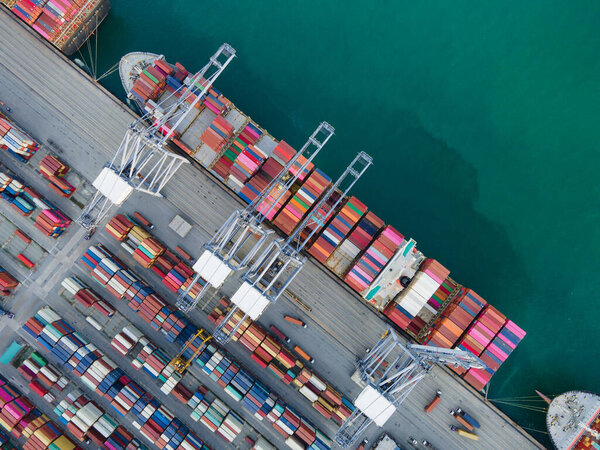 Aerial Top View business service and industry shipping cargo containers transportation logistics import export loading and unloading by crane