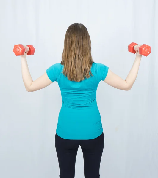 Girl with dumpbells sport concept gym — Stock Photo, Image