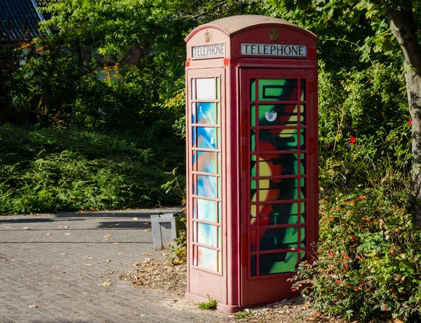 Painted old red phone booth, phone box, painted in different col — Stock Photo, Image