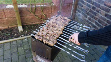 shashlik  - traditional russian barbecue.  meat on barbeque. smo clipart
