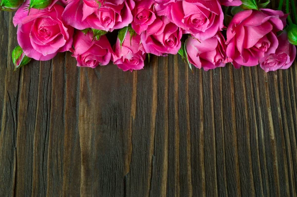 Rosebuds on wooden background — Stock Photo, Image