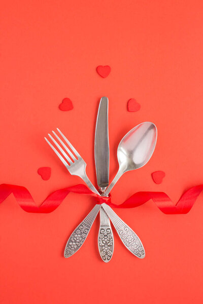 Top view of festive table setting for Valentine 's day on the red background