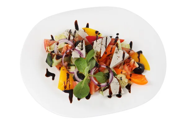 Cold starter, Greek salad on white plate, studio shot, isolated. — Stock Photo, Image