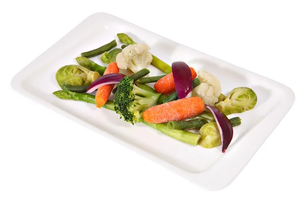 Vegetarian cuisine, steamed vegetables on a long flat white plater. — Stock Photo, Image