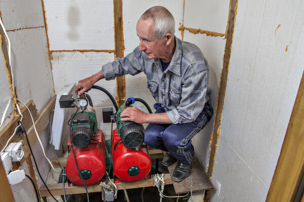 Farmhouse pumping station room, farmer pumps installed in village well.