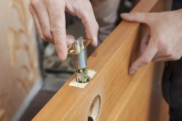 Close-up carpenter hands door lock installation. — Stock Photo, Image