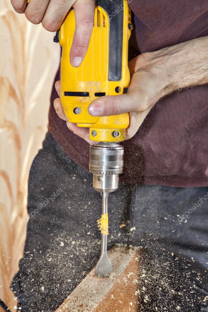 Door Knob Installing Using Yellow Power Drill Sawdust