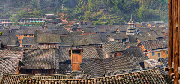 Tile roofs of wooden houses in large ancient chinese village.
