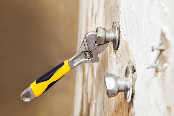 Close-up eccentric tap adjusts position with plumbers adjustable spanner. — Stock Photo, Image