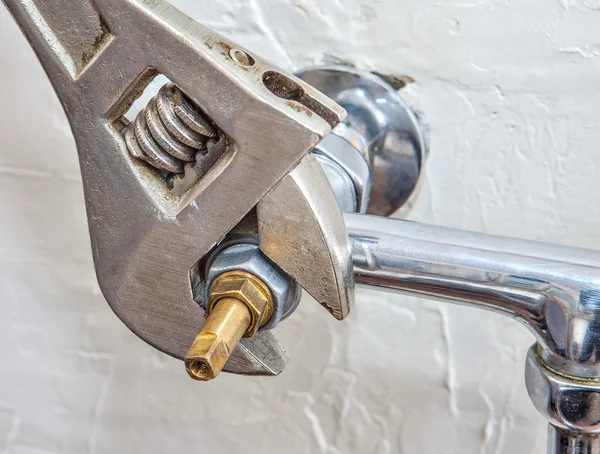 Plumber fixing water tap with leaking water — Stock Photo, Image