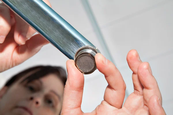 Unscrewing a faucet aerator for cleaning. — Stock Photo, Image
