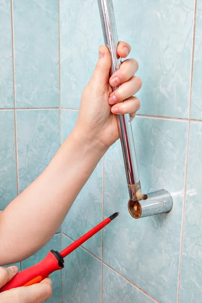 Ersätta vertikala hållare för duschmunstycke, med skruvmejsel, närbild. — Stockfoto