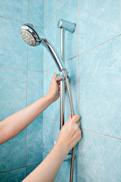 Close-up of human hand adjust the height holder shower head. — Stock Photo, Image
