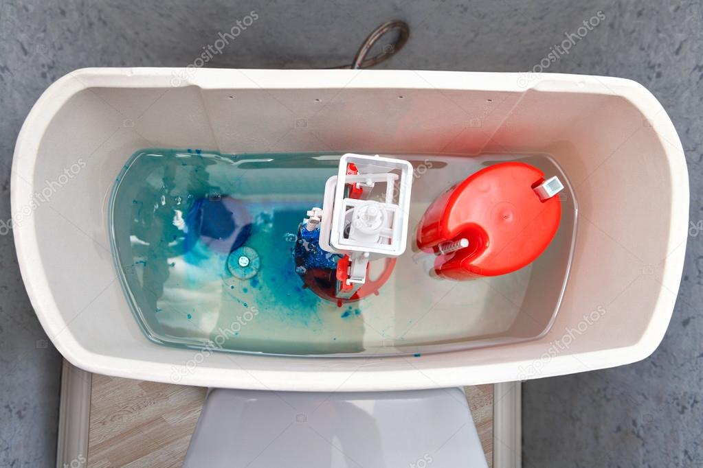 Flush mechanism inside cistern of toilet, blue water tablet diss