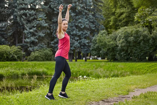 Young woman makes yoga in park for healthy at daytime. — Stock Photo, Image