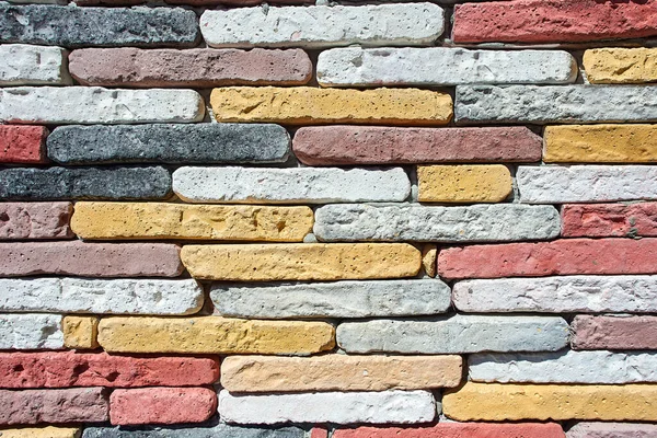 Wall of colored homemade bricks as texture for background. — Stock Photo, Image