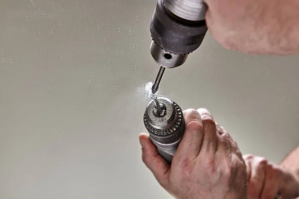 Bit for glass is clamped in drill chuck while drilling mirror. — Stock Photo, Image