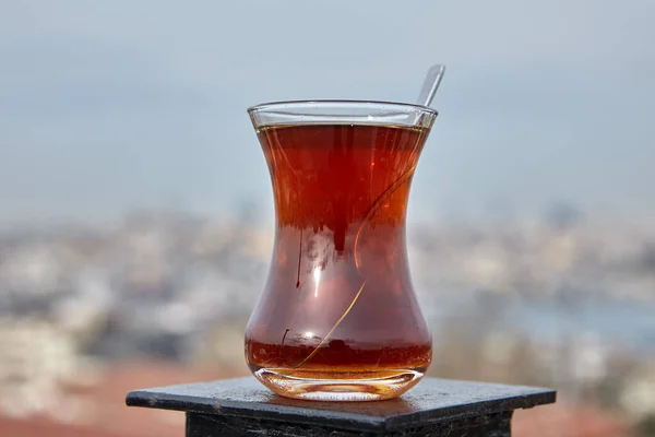 Armudu with Turkish tea stands atop rooftop fence, with defocused view of Istanbul. — Stockfoto