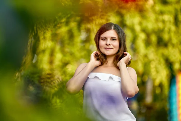 Happy woman is standing in city garden during walking. — Stock Photo, Image