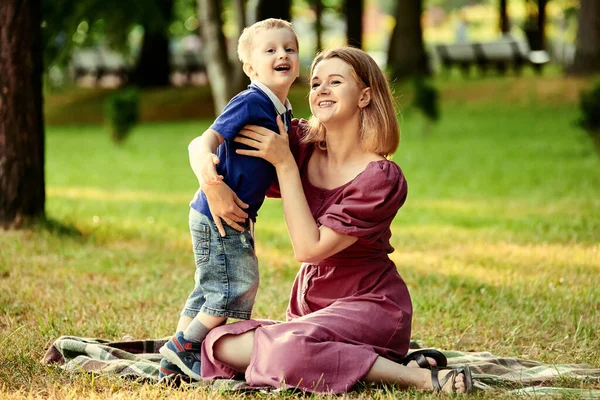 Smiling woman with little boy walk in public park. — Stock Photo, Image