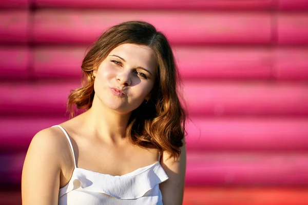 European happy woman sits outdoors near building. — Stock Photo, Image