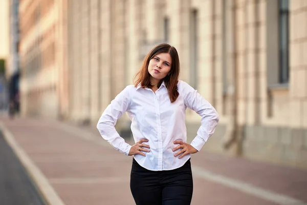 Young woman makes grimace while stands outdoors at daytime. — Stock Photo, Image