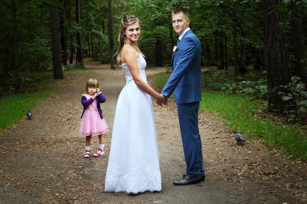 Wedding walk, newlyweds with child walking in forest. — Stock Photo, Image