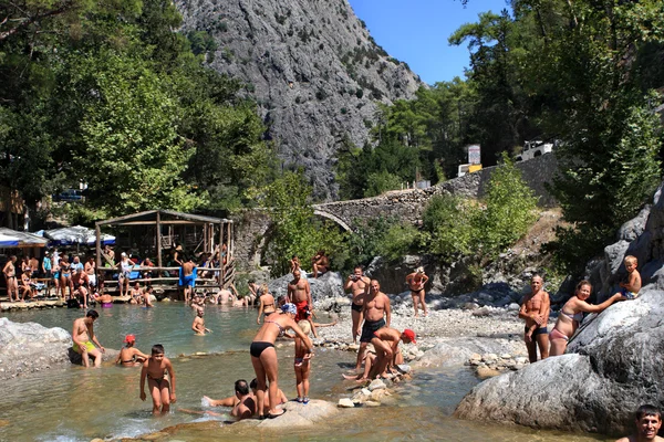 Kemer, Turkey,  Taurus Mountains, Tourists swimming in a mountain river. — Stock Photo, Image