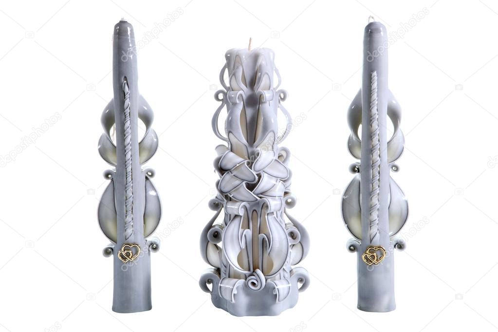Three decorative ribbon, carved handmade candles, isolated on wh