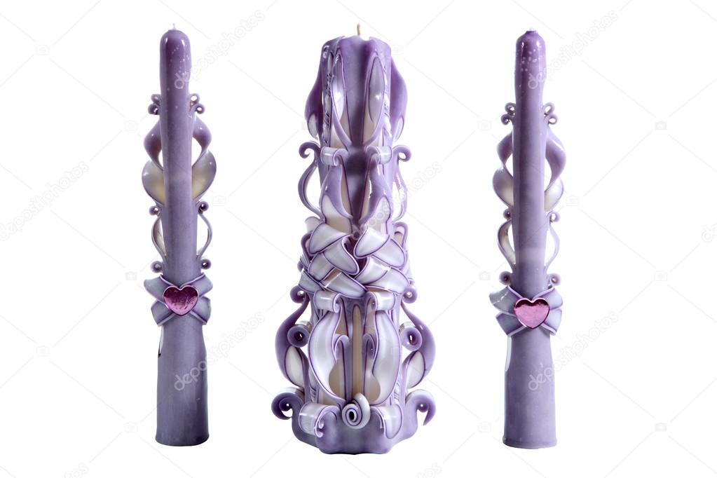 Three purple ribbon, carved candles for Christmas, or a wedding.
