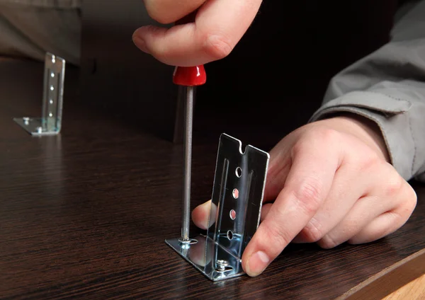 Furniture assembly, installation brackets slide rails with a hand screwdriver. — Stock Image Furniture assembly, installation brackets slide rails with a hand screwdriver. Stock Image
