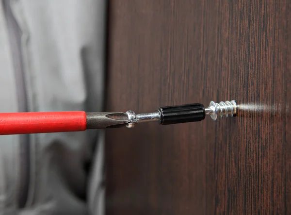 Screw wrapped in wooden plank close up — Stock Photo, Image