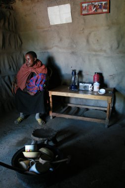  Internal view Masai home, black girl with baby are indoors. clipart