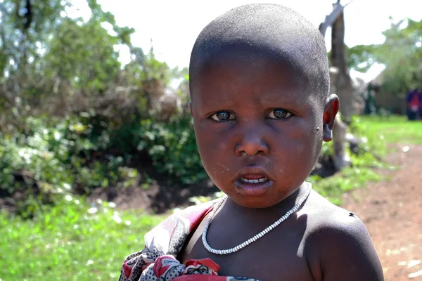 One black african child with a dirty face, closeup portrait.