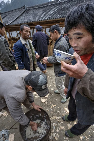 Asiatic man drinking by cup on a rural feast. — Stock Photo, Image