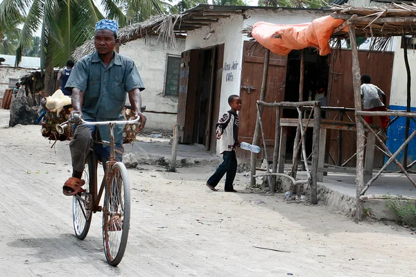 Muslim riding bike over dirt road fishing village — Stock Photo, Image